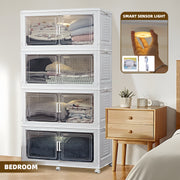 Stackable storage cabinet with transparent doors in a bedroom setting.