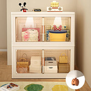 A stackable white storage bin with transparent doors and multiple compartments, containing various household items.
